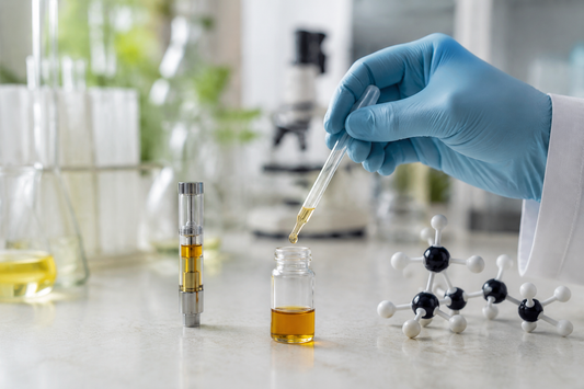 “A gloved researcher transfers amber cannabinoid distillate into an unmarked vial beside a transparent cartridge and molecular model in a bright laboratory.”