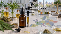 THCX oil and vape displayed with formulation ingredients, hemp, laboratory testing equipment, legal scales and a map of Europe.